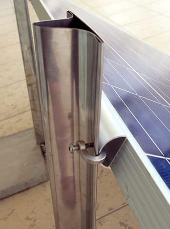 Curved Pinpoint Solar sheet-metal rail clamped to a photovoltaic module frame