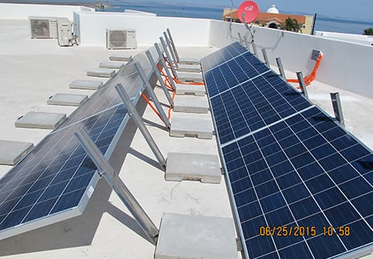 Pinpoint Solar photovoltaic modules mounted on freestanding ballasted supports on a flat roof