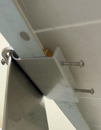 Underside view of a Pinpoint Solar folded metal bracket attached to a solar module frame
